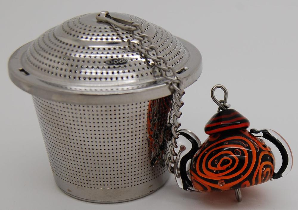 Tea infuser, teapot,  orange lines on black
