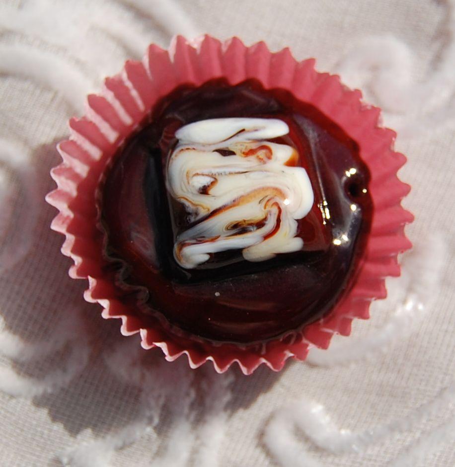 Dark chocolate decorated with a square of milk chocolate