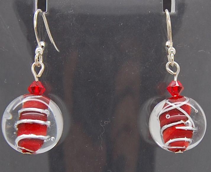 Earrings, silver wire on red